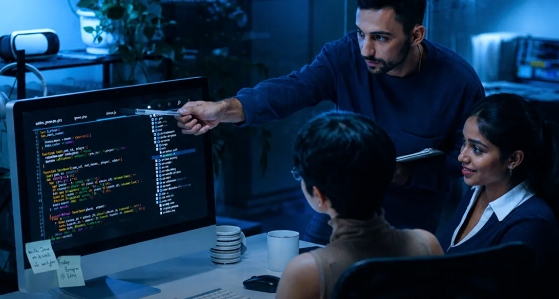 Developer team reviewing code together